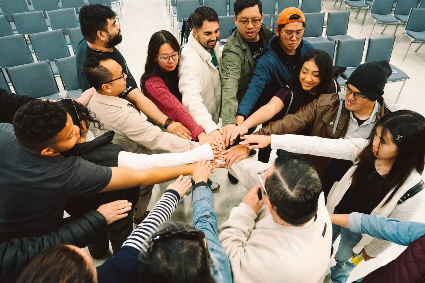 A small group praying together, hands on shoulders