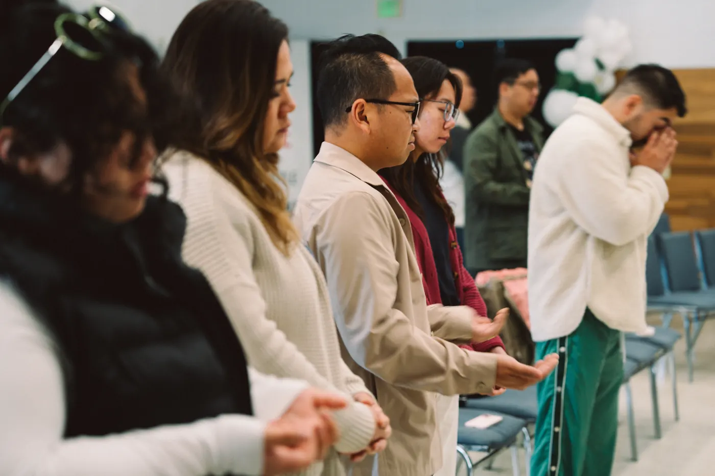 People connecting and praying together after a gathering